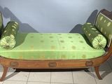 a green couch that is sitting on a tile floor