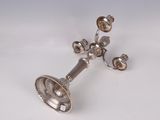 a silver plated candle holder with four candles on it