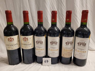 six bottles of wine are lined up in a row on a table