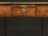 an old wooden table with two drawers and a gold decoration