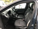 the interior of a car with the door open and the driver ' s seat down