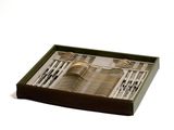 a tray with silverware in it on a white surface