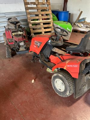 an image of a red lawn mower in a garage
