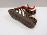 leopard print adidas sneakers with red soles on a white surface
