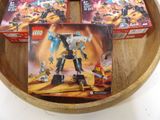 two boxes of legos in a wooden bowl on a table
