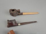 two pipe holders and a pipe holder on a table