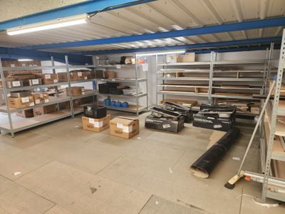 a large room with shelves and boxes on the floor