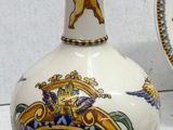 two vases and a plate sitting on a table