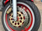 a red motorcycle parked on the side of the road
