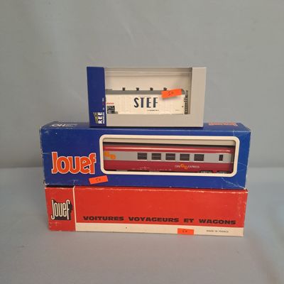 two boxes of toy trains sitting on a table