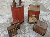 three old gas canisters sitting on a cement floor