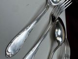 five spoons and two spoons sitting on a table