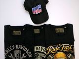two t - shirts and a hat are sitting on a table