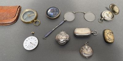 many different types of pocket watches and other items on the table