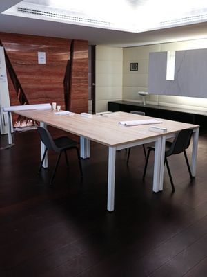 a table and chairs in a room with a skylight