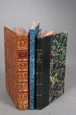 three books are stacked on top of each other on a table