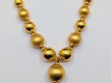 an image of a gold necklace on a white background