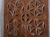 une photo d'une plaque en bois ornée d'un motif floral