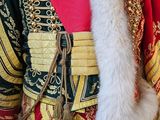 a mannequin dressed in a red and gold outfit