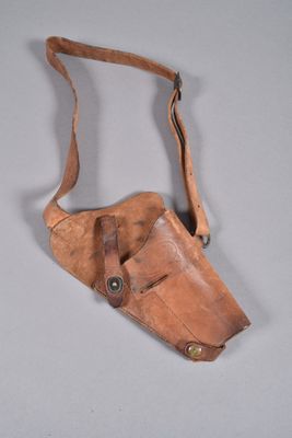 an old leather holster with a leather strap hanging from it ' s side