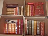 Plusieurs cartons de livres sont empilés les uns sur les autres