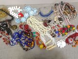 a lot of jewelry that is laying out on the table