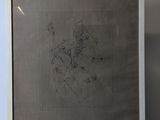 a framed drawing of a man riding a horse in a field