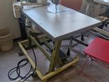 a table with a sewing machine on it in a room