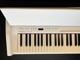 a white piano with black and red keys on it