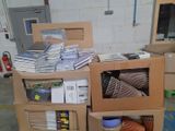 a pile of books on top of a carton in a room