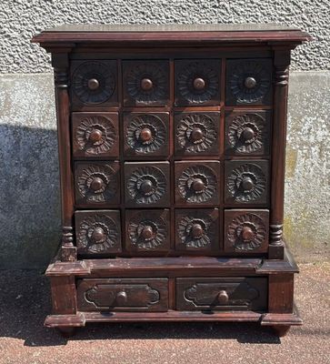 an old wooden chest of drawers with many drawers on it