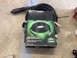 a box with a hose on the floor next to other items