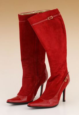 a pair of red high heeled boots on a white surface