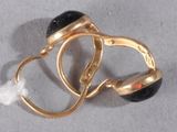a gold ring with a black stone on top of it