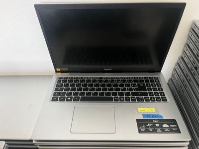 a laptop computer sitting on top of a stack of books