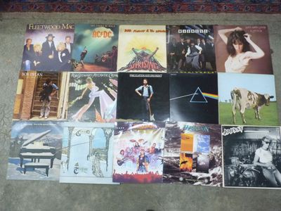a lot of pink floyd album covers on the floor