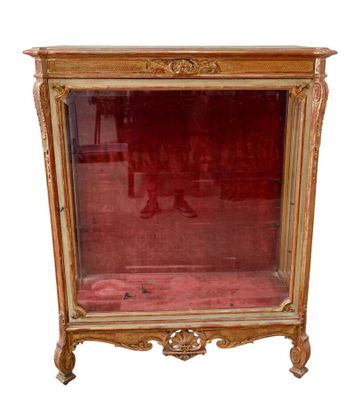 a glass display case with a red cloth on it