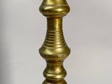a gold candle that is sitting on a table