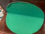 a wooden table with a green cushion on it