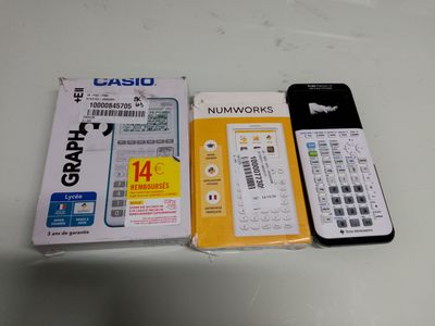 a calculator, a cell phone and a package of cards on a table