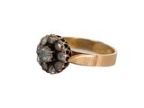 a close up of a gold ring with a cluster of black diamonds