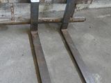 two forks that are sitting on a pallet