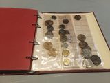 a red book with a bunch of coins inside of it