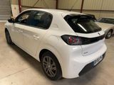 the rear end of a white car parked in a garage