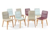 several different colored chairs are arranged in a circle on a white surface