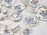 many plates and cups and saucers on the table