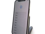 a phone that is sitting on a stand on a table