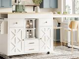 a white kitchen island in the middle of a room