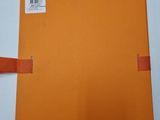 an orange folder with a piece of paper attached to it
