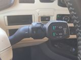 a car dashboard with a steering wheel and a cell phone in it